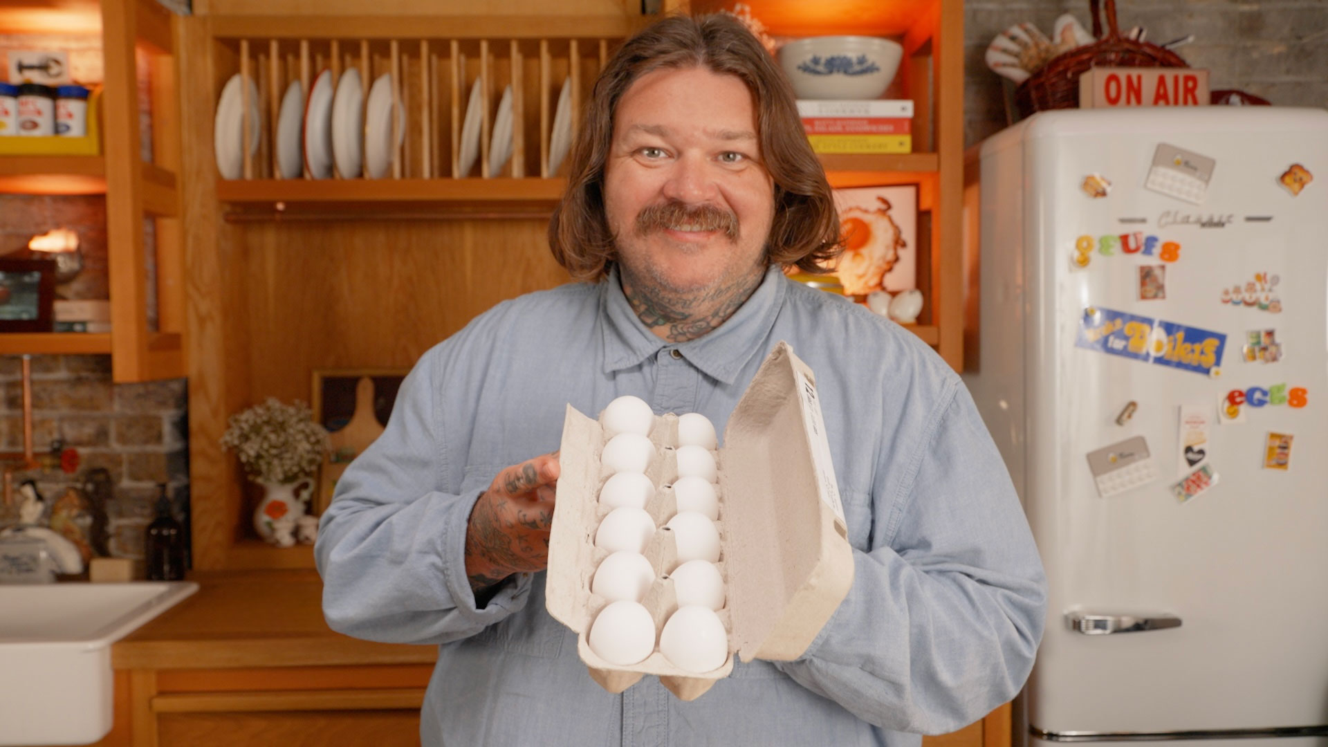 Matty Matheson holding a carton of white eggs.